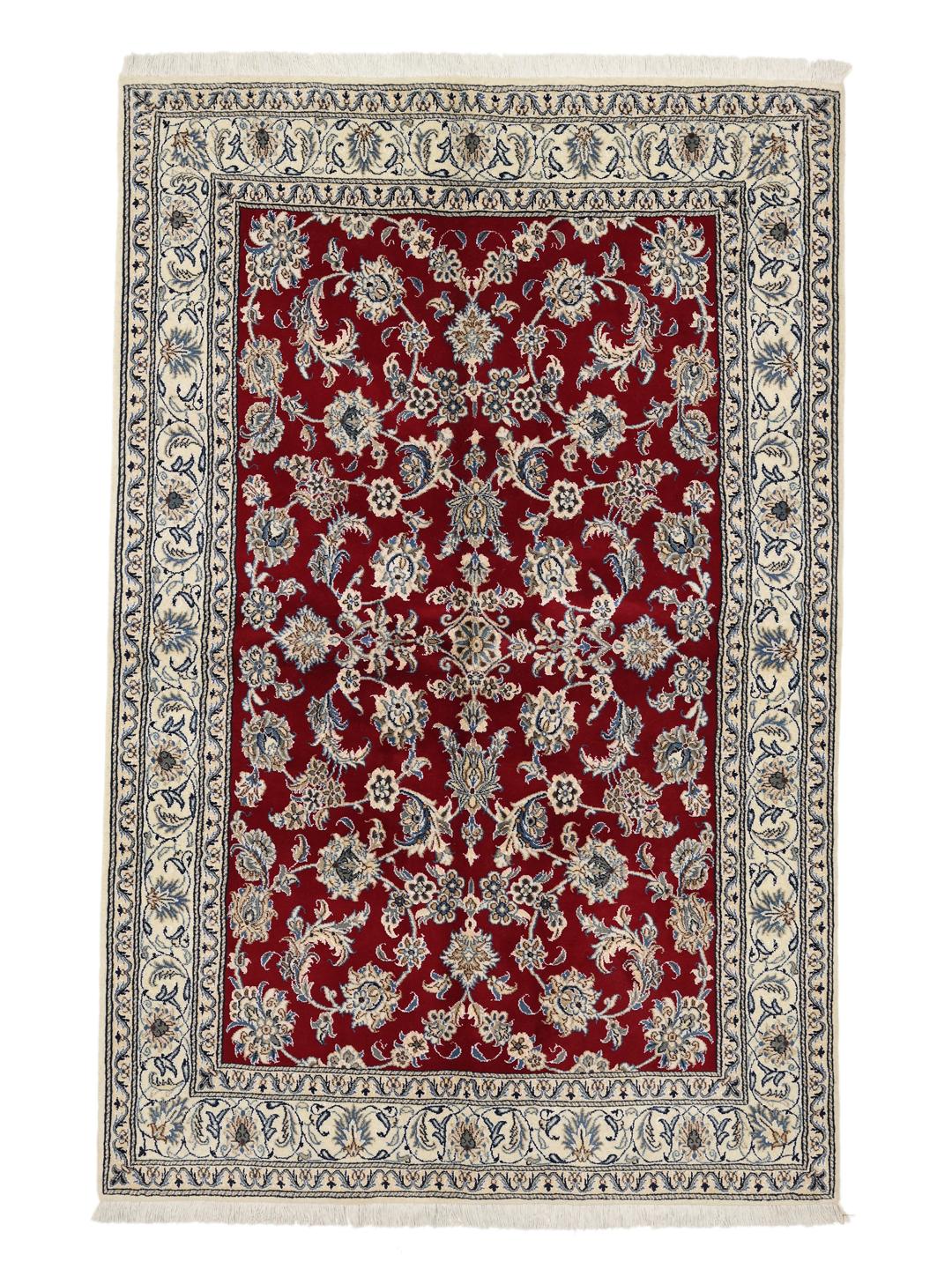 Hand-knotted Nain rug from the Middle East in deep red with floral patterns
