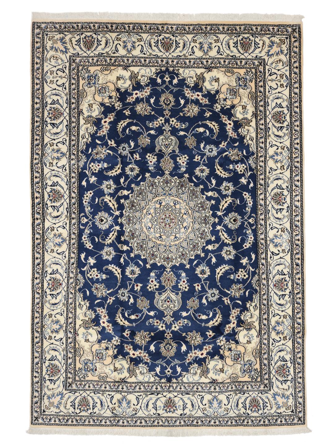 Hand-knotted Nain rug from the Middle East with a deep blue field and floral motifs