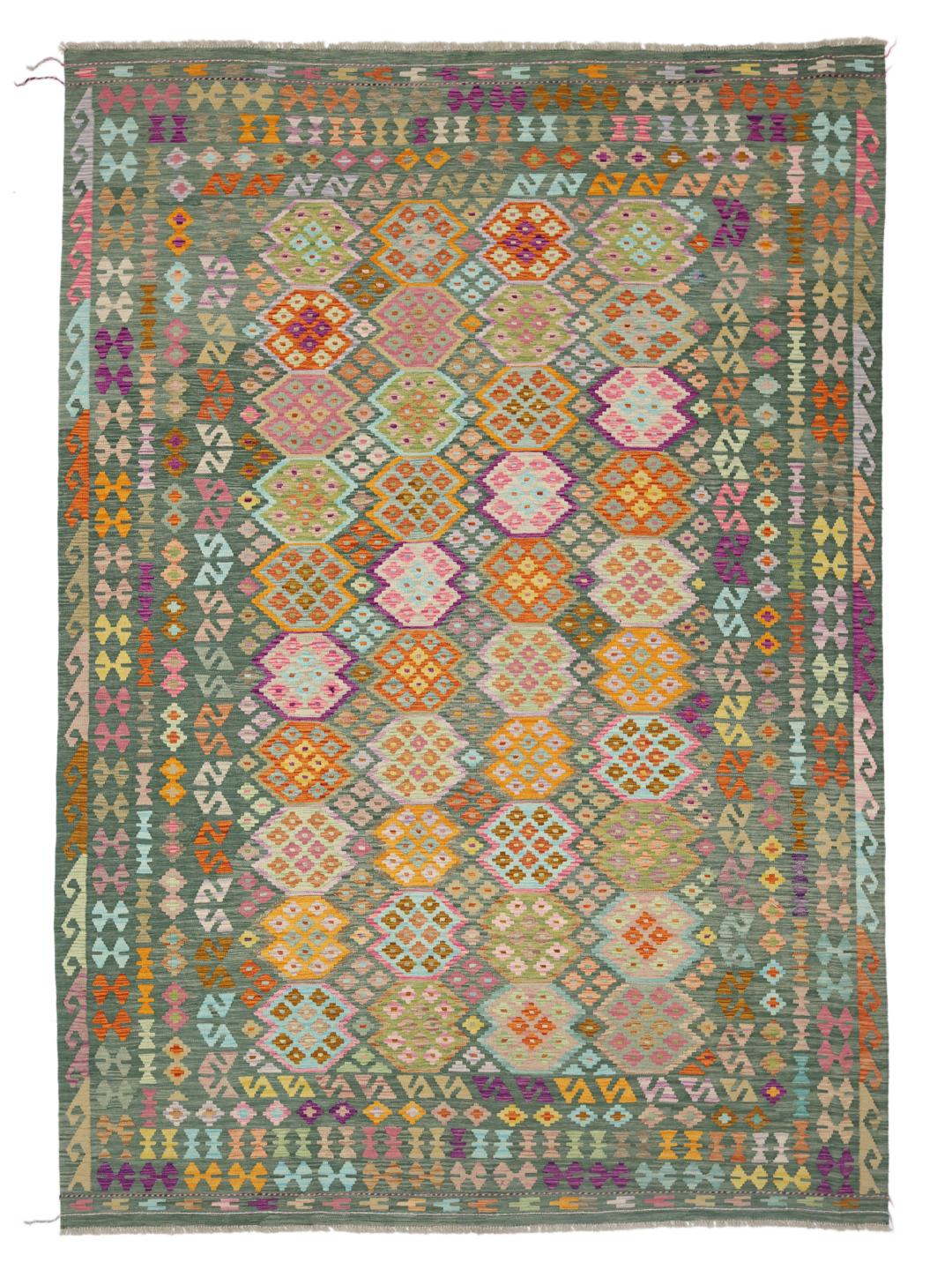 A large, rectangular Afghan Kelim rug featuring a multicolour geometric pattern on a green field.