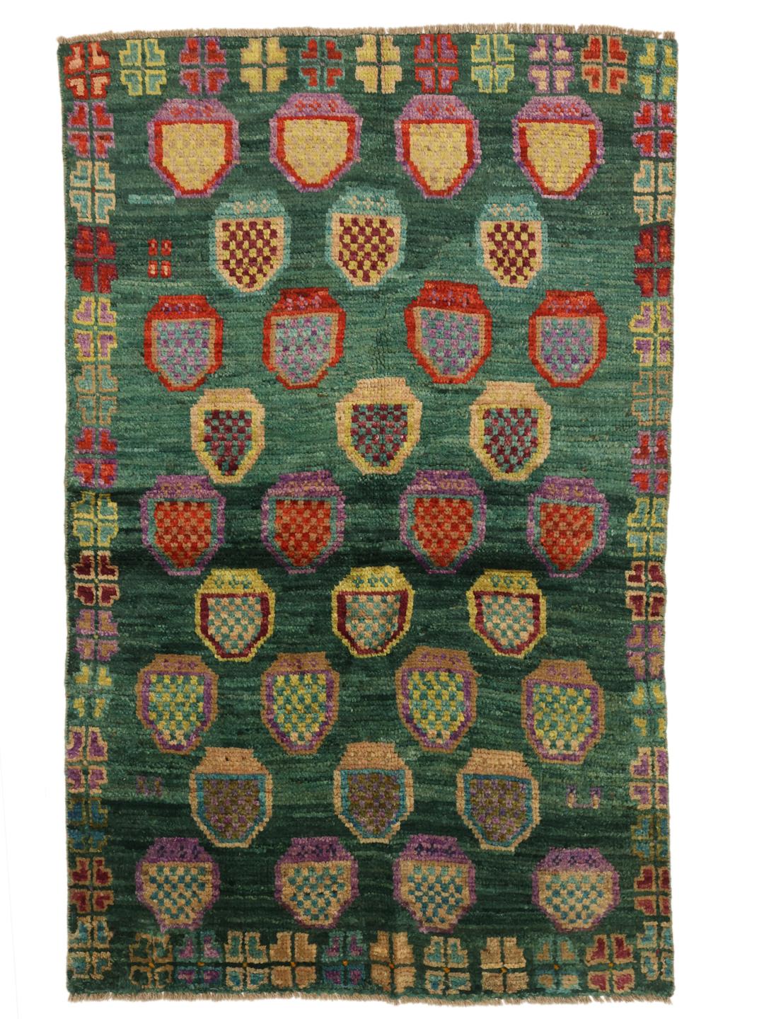 Hand-knotted Afghan rug with a vibrant green field and colourful geometric motifs.
