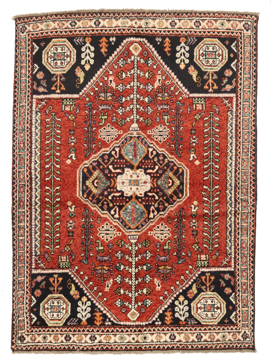 Hand-knotted Kazak rug from Afghanistan featuring red and black geometric patterns.