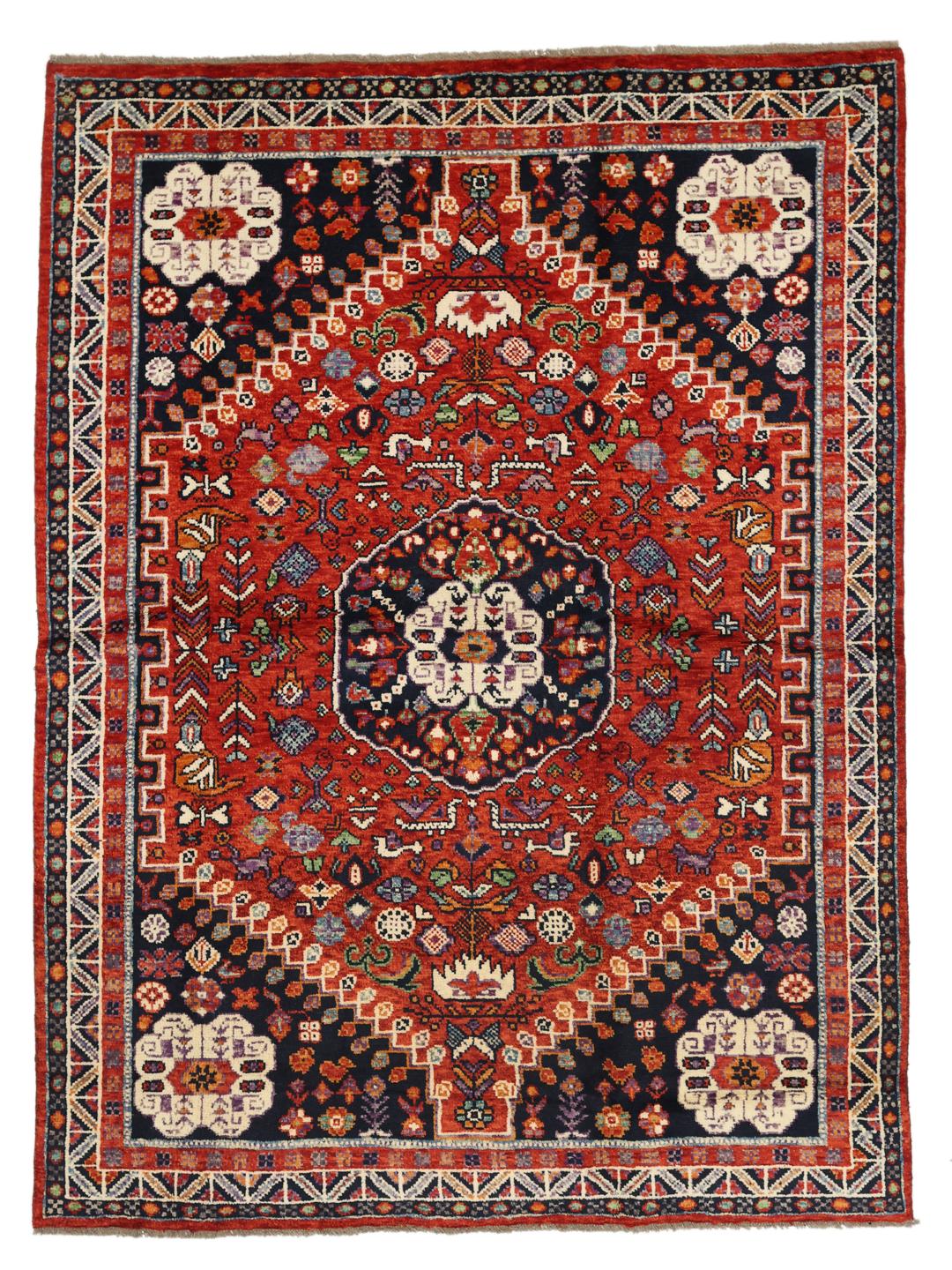 Hand-knotted Kazak rug from Afghanistan featuring a deep red and blue geometric design.