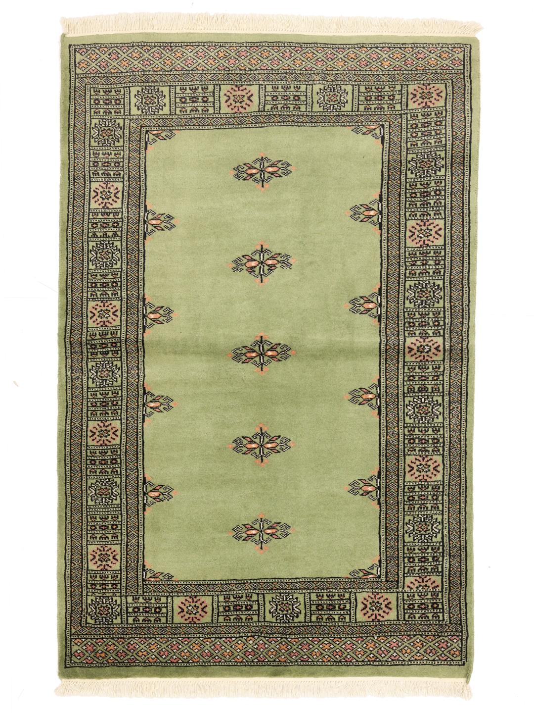 Handmade Pakistan rug in light-green with traditional motifs