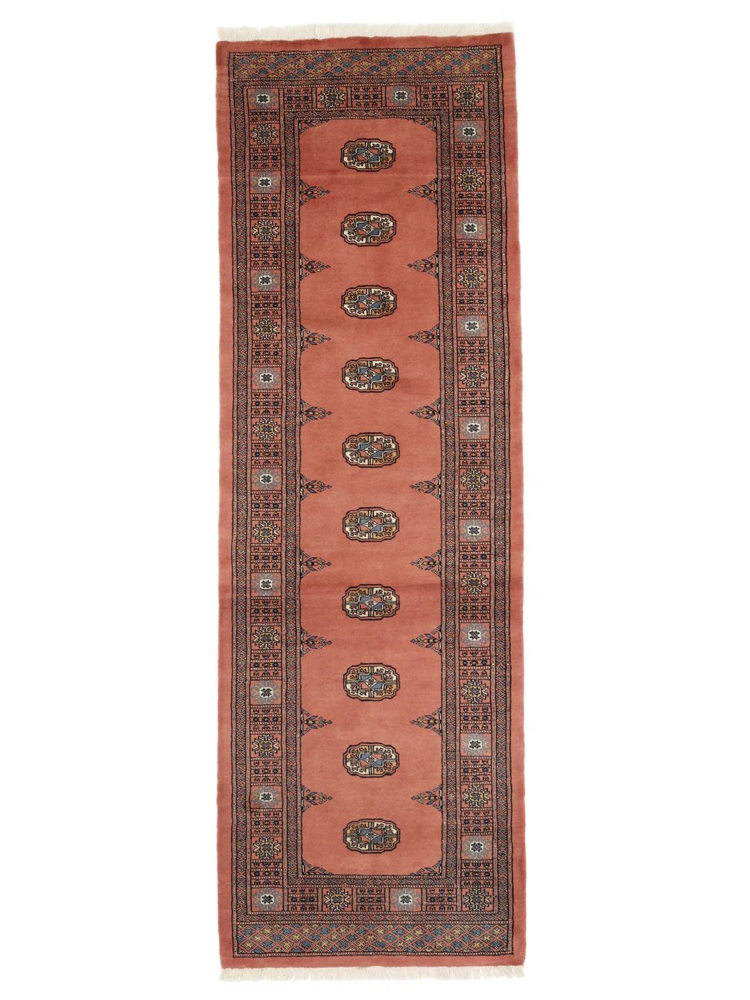 Handmade runner rug from Pakistan in dark red