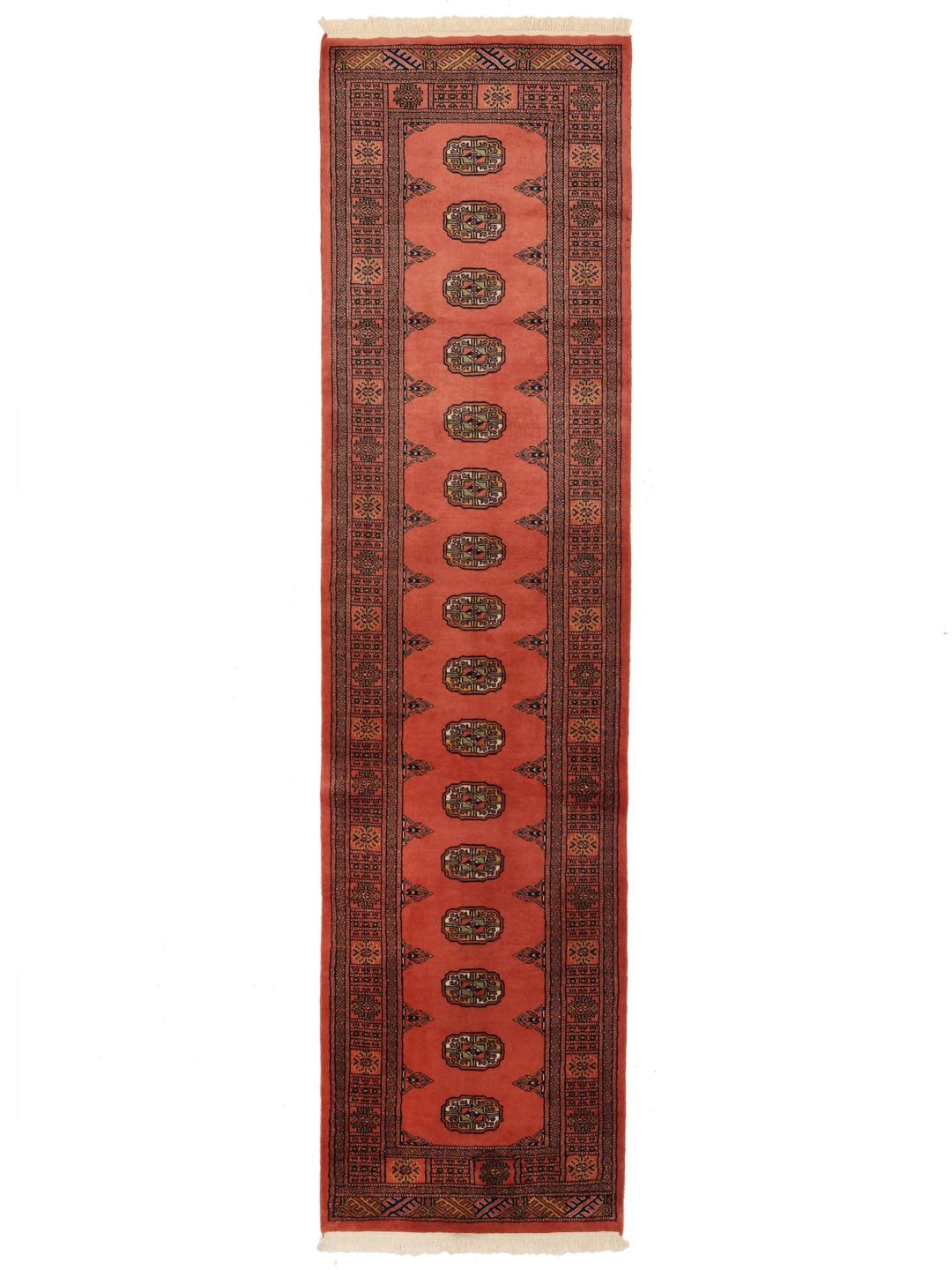 Red runner rug from Pakistan with traditional motifs