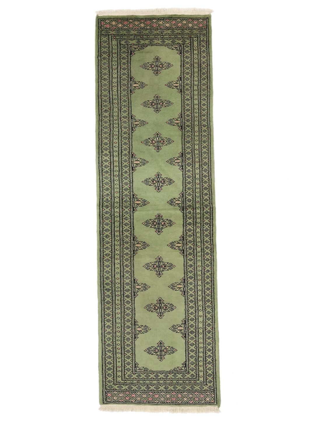 Handmade runner rug from Pakistan in light-green.