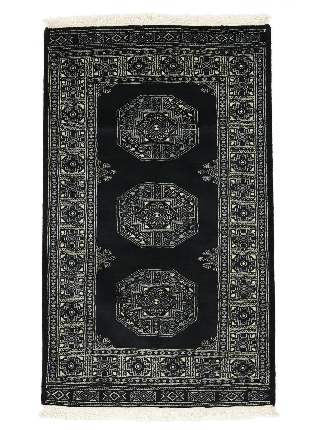 Handmade Bokhara rug from Pakistan in black with traditional motifs.